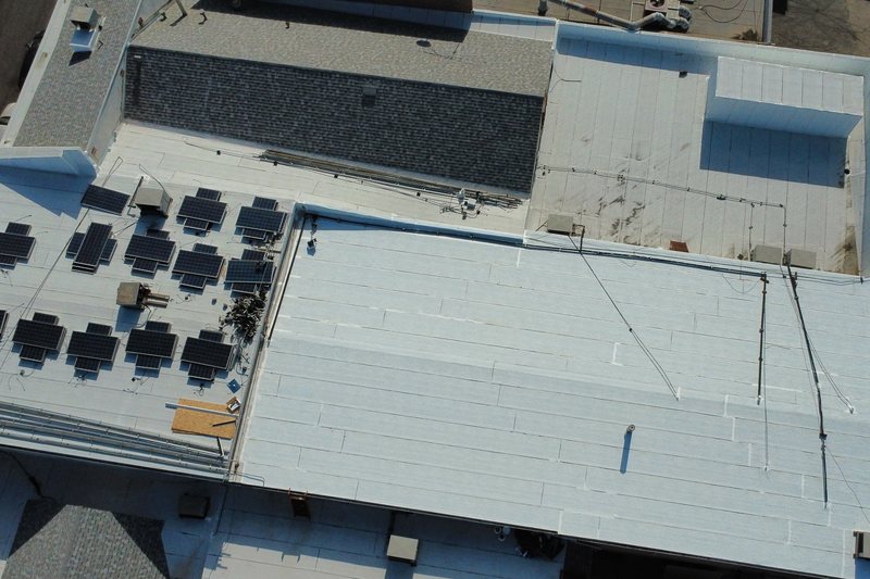 Aerial view of a commercial low-slope roof and rooftop equipment