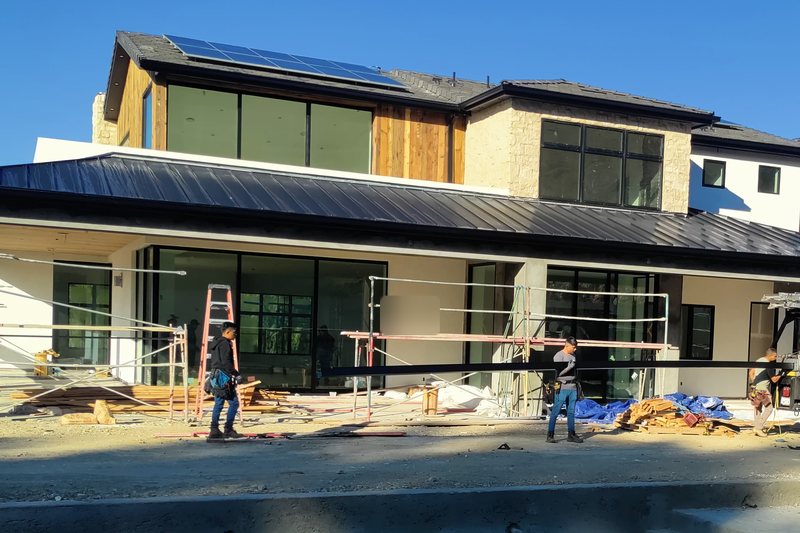 Standing-seam metal rooflines across a residential construction property