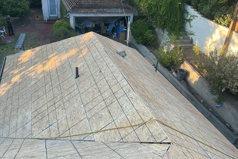 Exposed roof deck with layout lines during replacement work