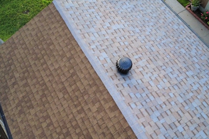 Aerial view of adjoining residential shingle roof sections
